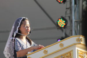 A Girl at Podium Reading Braille