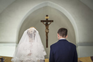 Bride and groom getting married at the altar.
