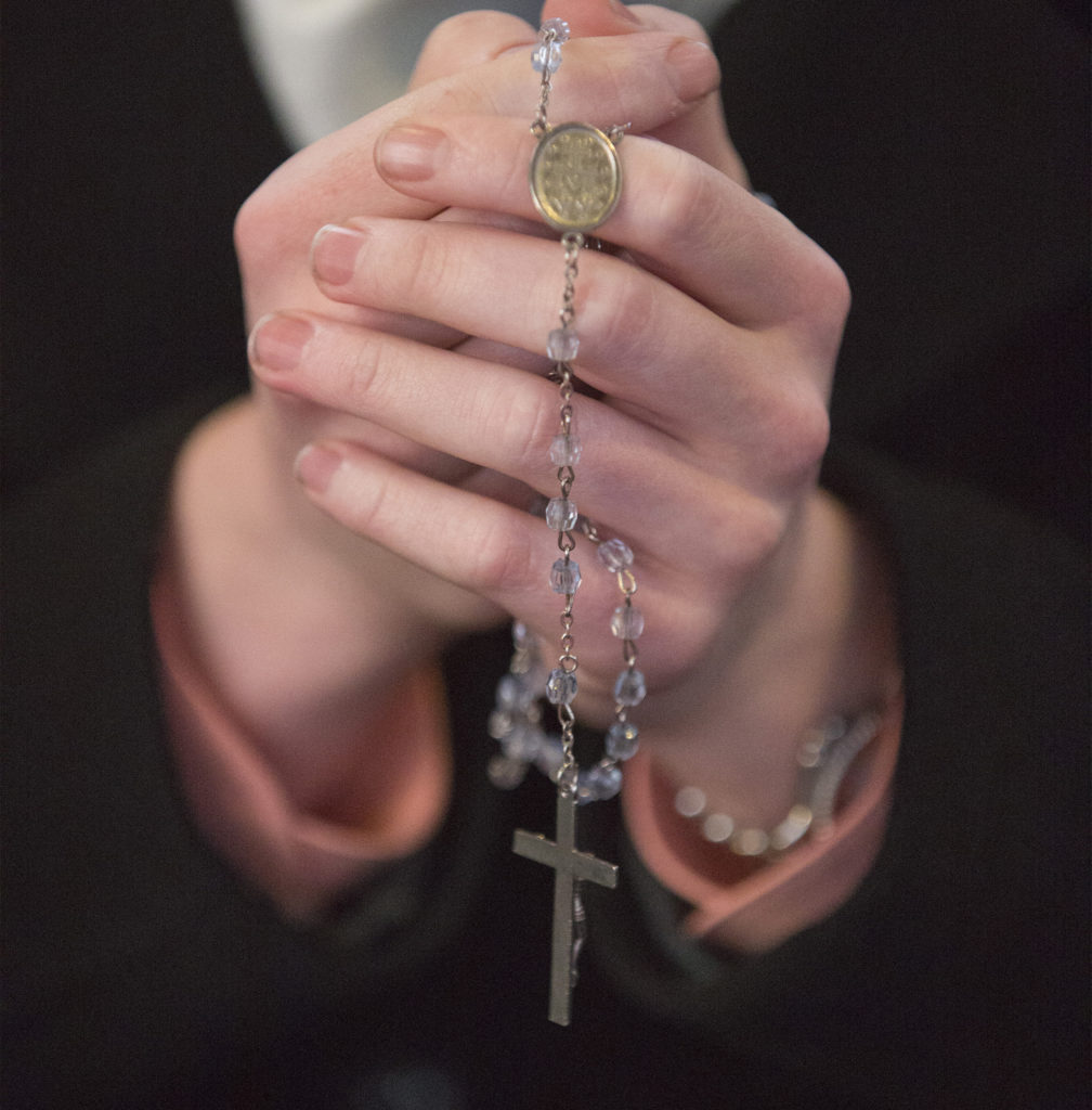 hands praying with rosary