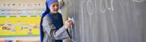 Teacher at chalkboard