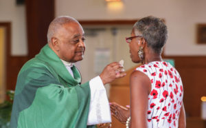 Archbishop Gregory distributes communion.