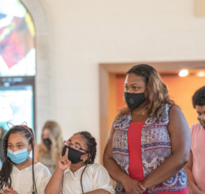 People wear masks while attending Mass