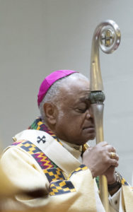 Archbishop Gregory prays