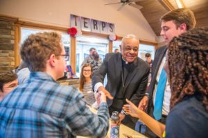 Cardinal Gregory greets college students.