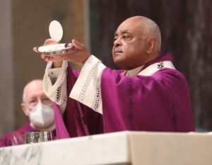 Cardinal Gregory elevates the Eucharist on Ash Wednesday