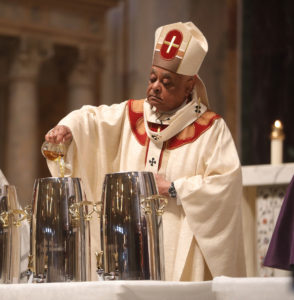 Cardinal Gregory mixes the sacred oils at the Chrism Mass.