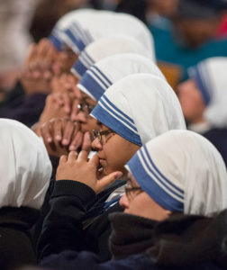 Religious sisters pray.