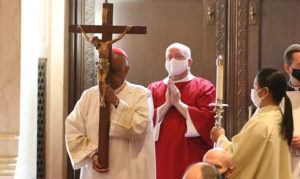 Cardinal Gregory processes with the cross on Good Friday at the Cathedral of St. Matthew the Apostle.