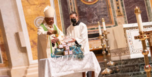 Cardinal Gregory blesses seeds after Mass.