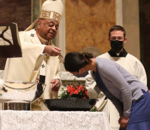 Cardinal Gregory baptizes new member of the Roman Catholic Church.