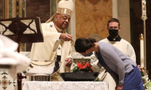 Cardinal Gregory baptizes new member of the Roman Catholic Church.