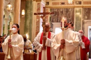 Cardinal Wilton Gregory holds the cross