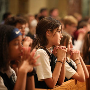 Students praying at Mass for Vocations