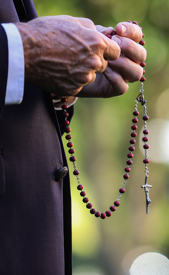 Man Praying Rosary