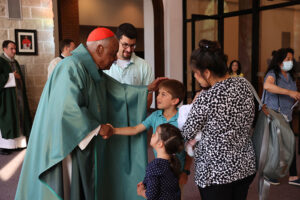 Cardinal Gregory greets a family