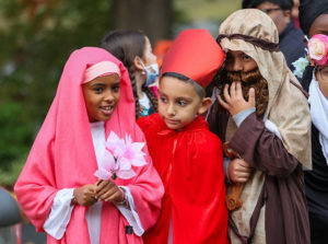 students from St. Francis International School participated in a Heroes and Holy People Parade