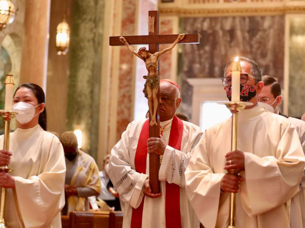 Cardinal Gregory processes with the cross on Good Friday at the Cathedral of St. Matthew the Apostle.