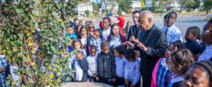 Washington Archbishop Wilton Gregory helps plant trees with students.
