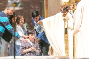 bautiza a un niño durante la Vigilia Pascual