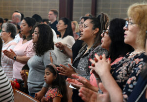 People praying during a Mass at St. Rose of Lima Church