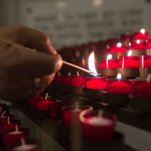 A man lights a candle.