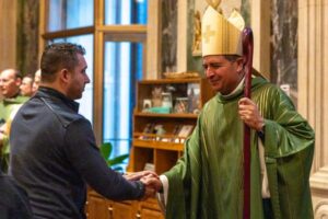 Bishop Menjivar greets a Mass participant.