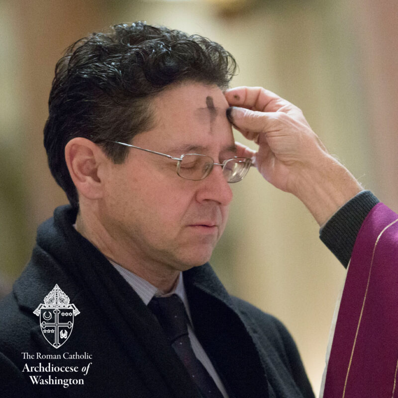 Ash Wednesday Photo of Man receiving and Ash Cross on the forehead.