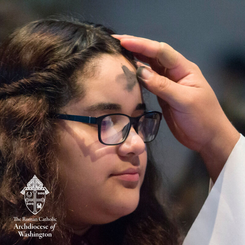 Ash Wednesday woman receiving Ash Cross on Forehead