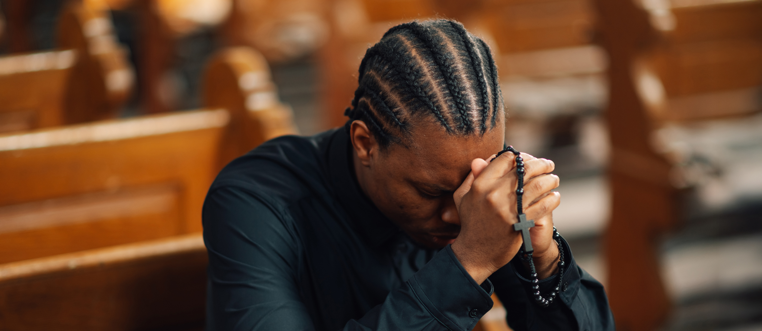 Young Adult Praying in Pew