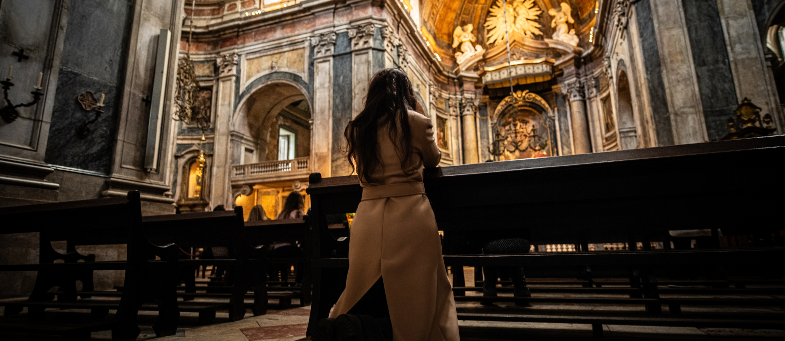 Young Adult Praying in Pew