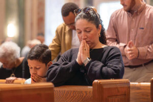 Praying at Good Friday Mass