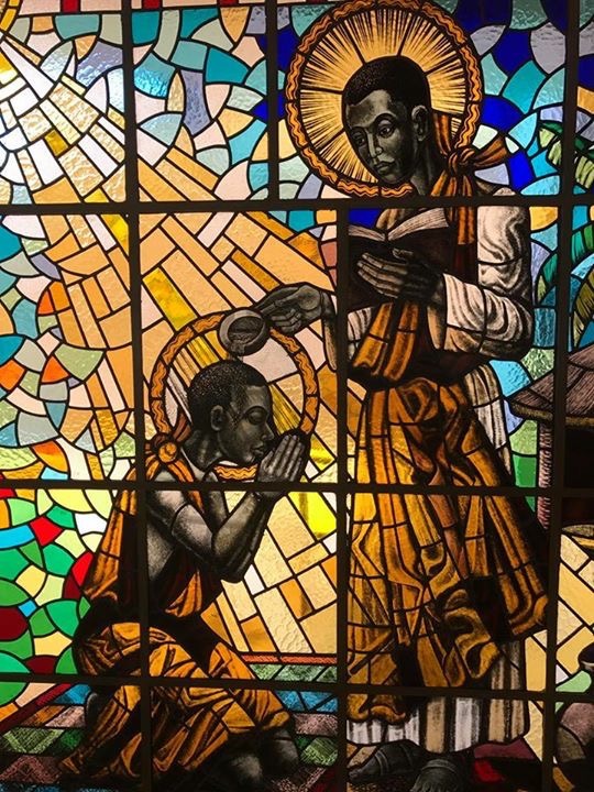 St. Kizito being baptised by St. Charles Lwanga at Munyonyo
